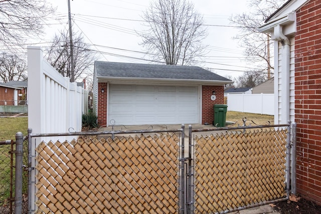 detached garage featuring a gate and fence