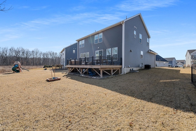 rear view of property with a wooden deck and central AC