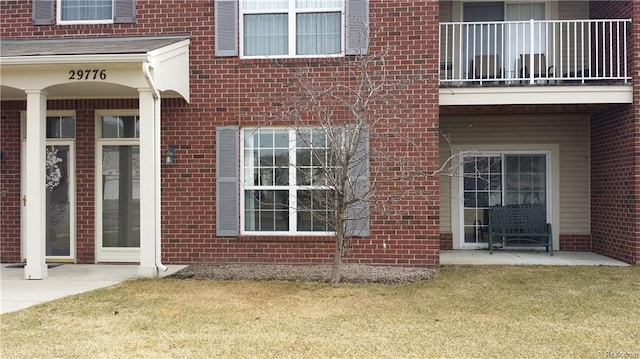 doorway to property with brick siding