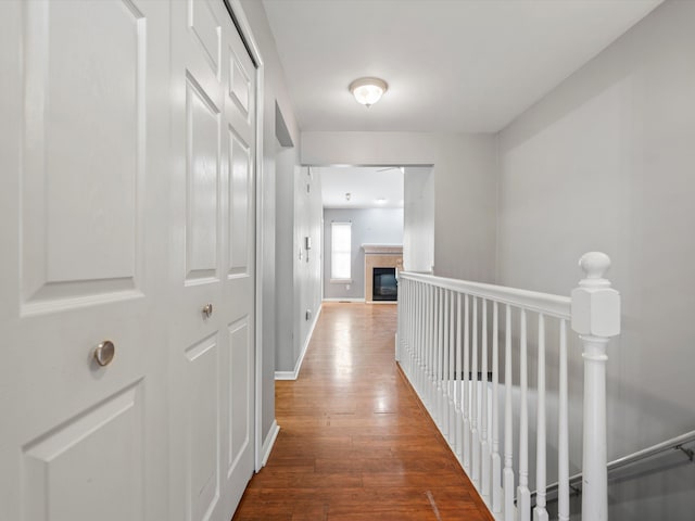 corridor featuring wood finished floors and baseboards