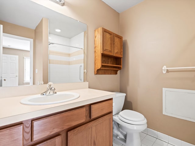 bathroom featuring toilet, tile patterned flooring, a tile shower, and vanity