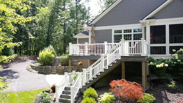 exterior space with stairway and a wooden deck