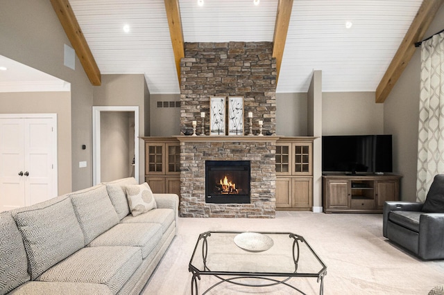 carpeted living room with vaulted ceiling with beams, a large fireplace, visible vents, and ornamental molding