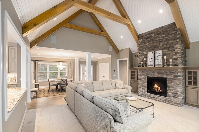 living room with high vaulted ceiling, a fireplace, decorative columns, and beamed ceiling