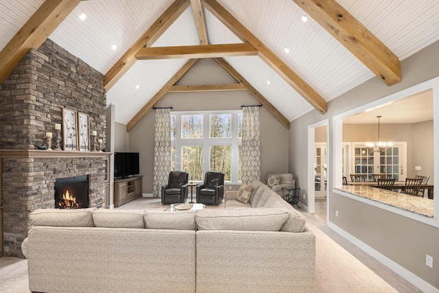 living room featuring a chandelier, carpet, a stone fireplace, high vaulted ceiling, and beam ceiling