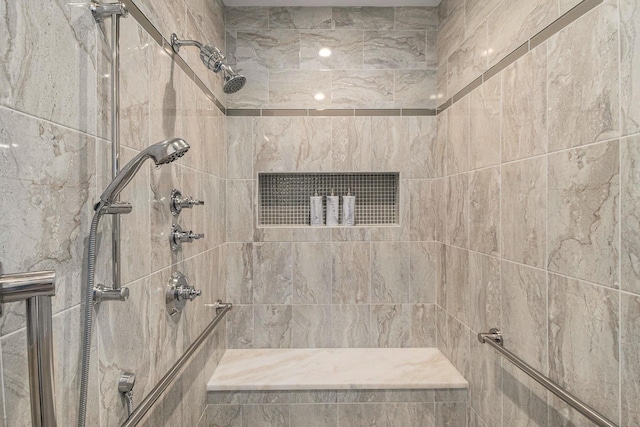 bathroom with visible vents and a tile shower