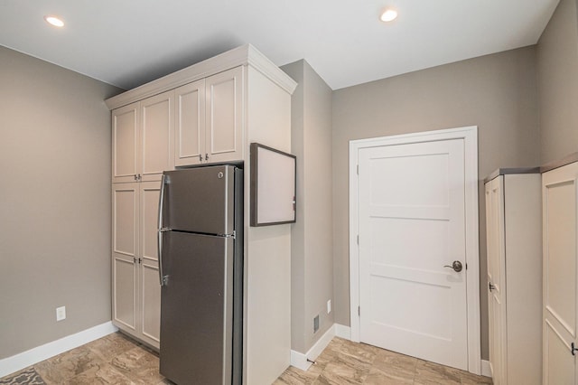 kitchen with recessed lighting, freestanding refrigerator, and baseboards