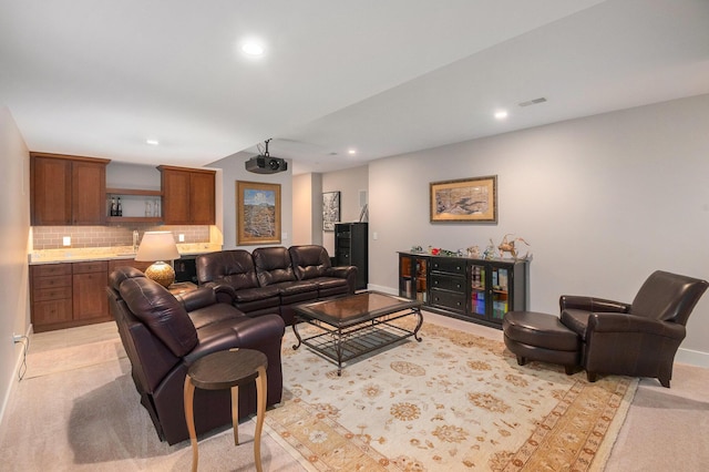 living area with light colored carpet, recessed lighting, and visible vents