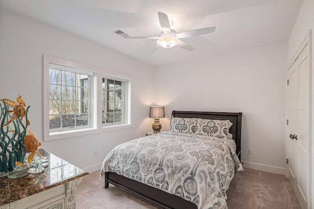 carpeted bedroom featuring a ceiling fan and baseboards