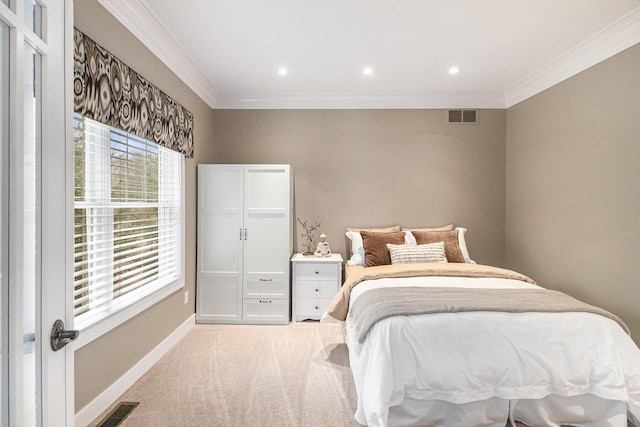 bedroom featuring carpet floors, baseboards, visible vents, and crown molding