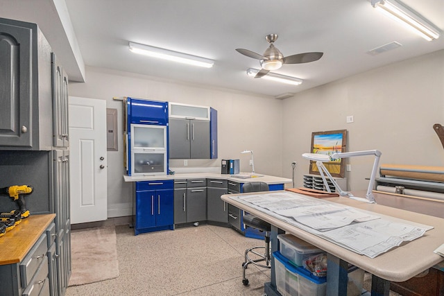 kitchen featuring light speckled floor, visible vents, and a ceiling fan