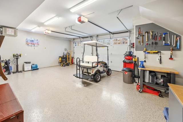 garage featuring a workshop area and a garage door opener