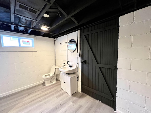 bathroom with vanity, toilet, and wood finished floors