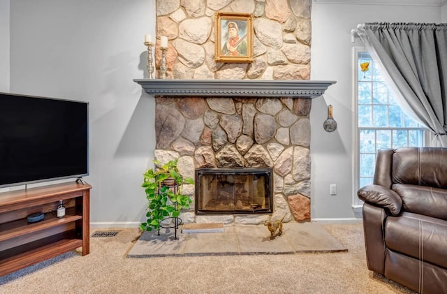 carpeted living room featuring baseboards and a fireplace