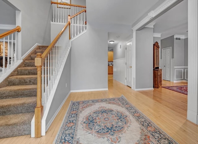 stairs with baseboards and wood finished floors