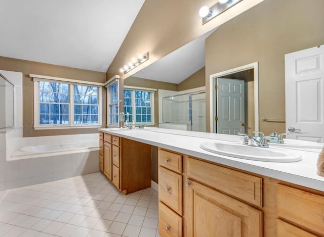 full bathroom featuring lofted ceiling, a sink, tile patterned flooring, a shower stall, and a bath