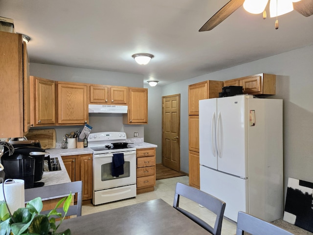 kitchen with white appliances, under cabinet range hood, light countertops, and a ceiling fan