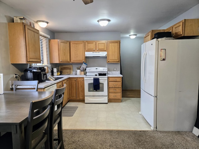 kitchen with light countertops, a sink, ceiling fan, white appliances, and under cabinet range hood