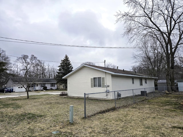 view of home's exterior featuring a yard, fence, and driveway