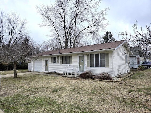 ranch-style house featuring a garage and a front lawn