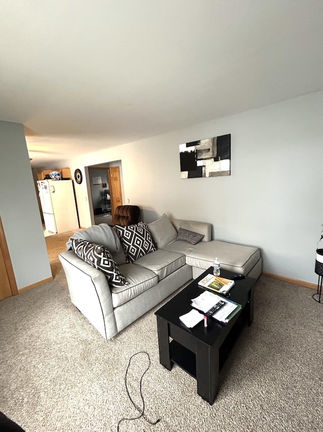 living room featuring carpet floors and baseboards