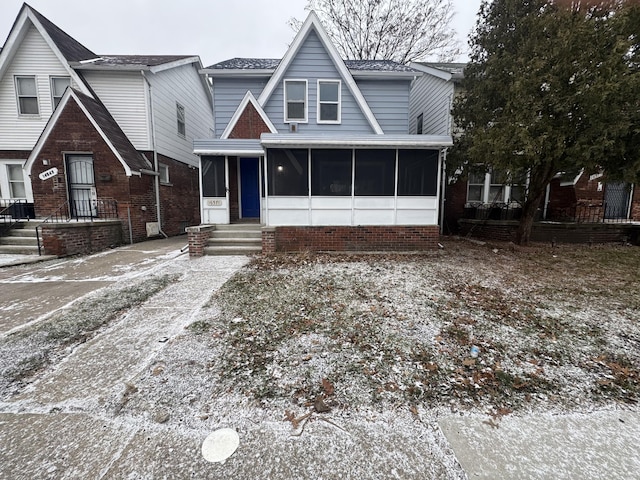 view of front of home featuring a sunroom