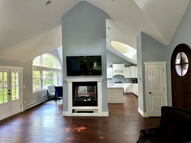 living area with dark wood-style floors, a baseboard radiator, baseboards, high vaulted ceiling, and a multi sided fireplace