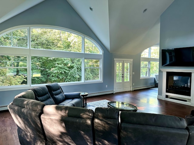 living area featuring a glass covered fireplace, baseboard heating, and wood finished floors