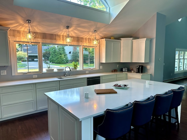 kitchen with light countertops, a sink, and a wealth of natural light