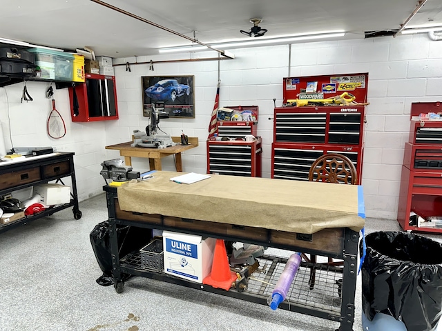 garage featuring concrete block wall and a workshop area