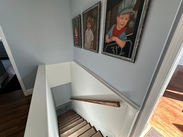 stairs with baseboards and wood finished floors