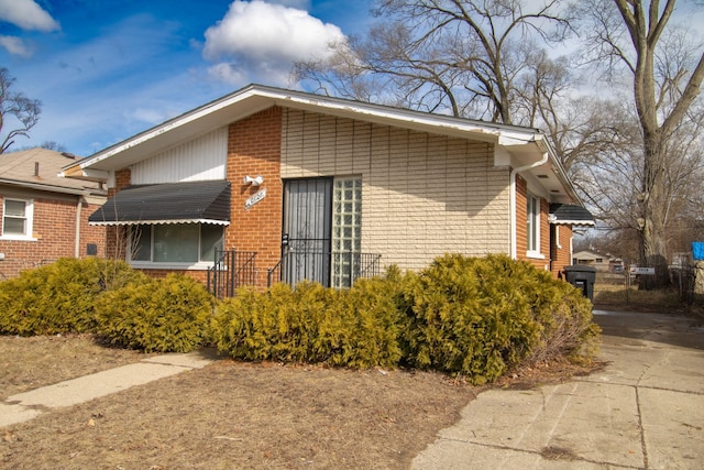 view of side of home with brick siding