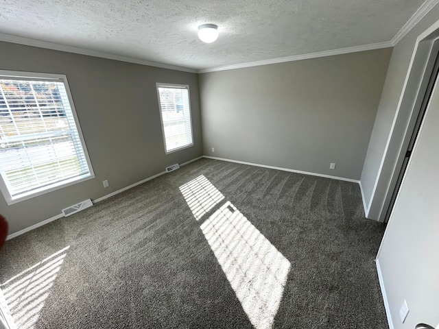 unfurnished bedroom featuring visible vents, baseboards, crown molding, and carpet