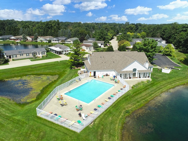 birds eye view of property with a water view and a wooded view