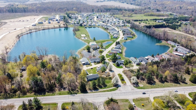 bird's eye view featuring a water view and a residential view