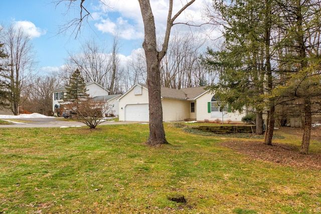 view of side of home with a garage, a lawn, and concrete driveway