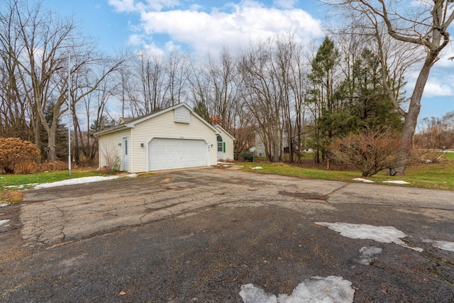 view of home's exterior featuring aphalt driveway and an attached garage