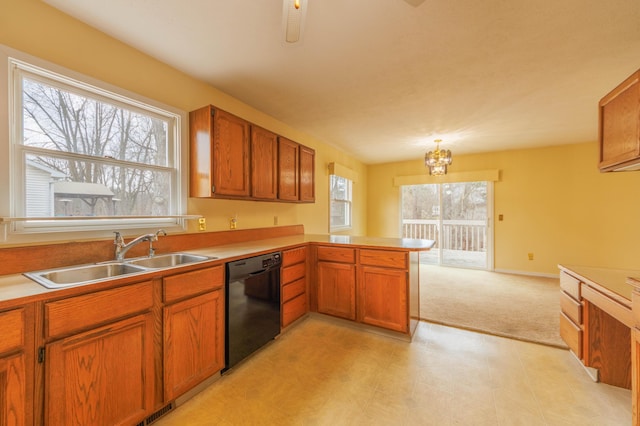 kitchen with light countertops, brown cabinetry, a sink, dishwasher, and a peninsula