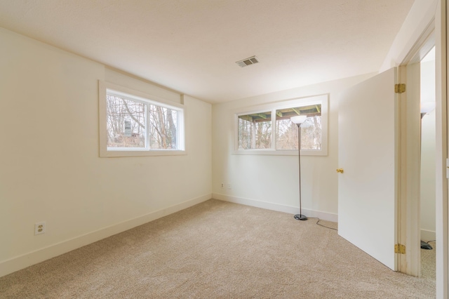 unfurnished bedroom with baseboards, visible vents, and light colored carpet