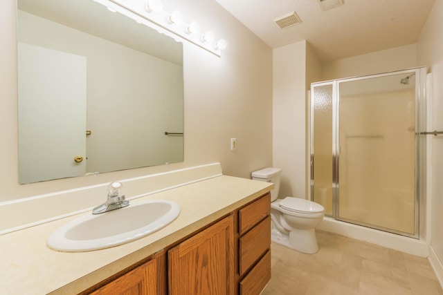 full bathroom featuring toilet, a stall shower, visible vents, and vanity