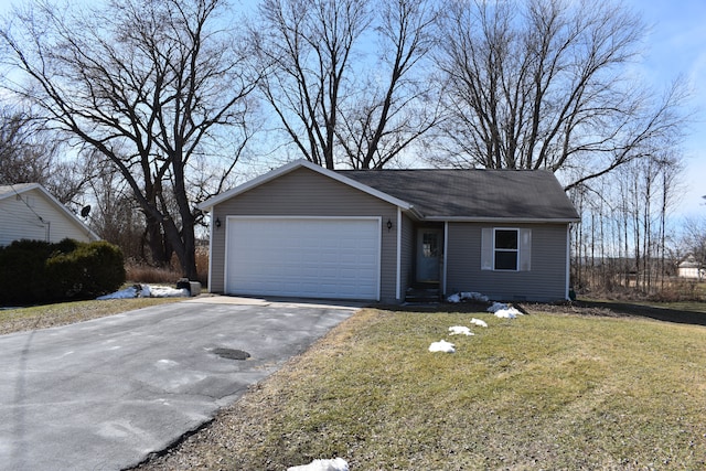 ranch-style home featuring a front yard, driveway, and an attached garage