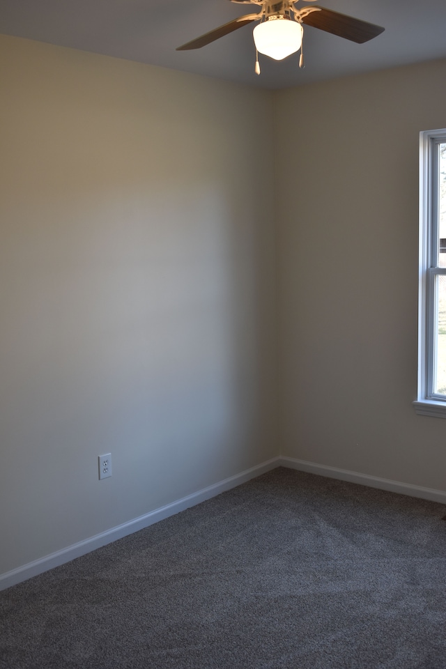 empty room featuring ceiling fan, carpet, and baseboards