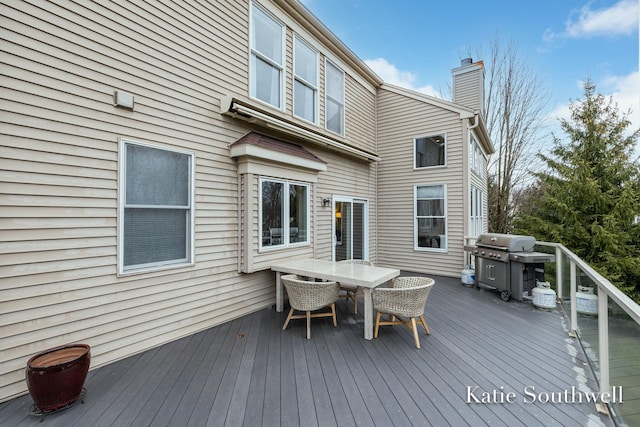 wooden terrace featuring outdoor dining area and area for grilling