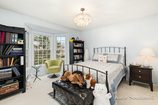 carpeted bedroom featuring a chandelier and baseboards