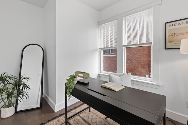 office space with baseboards and wood finished floors