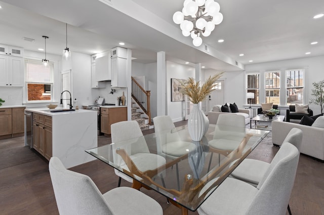 dining room featuring a chandelier, stairway, dark wood finished floors, and recessed lighting