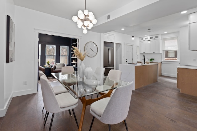 dining room featuring recessed lighting, dark wood-style flooring, baseboards, and an inviting chandelier