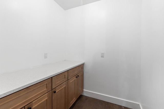 bathroom with wood finished floors and baseboards