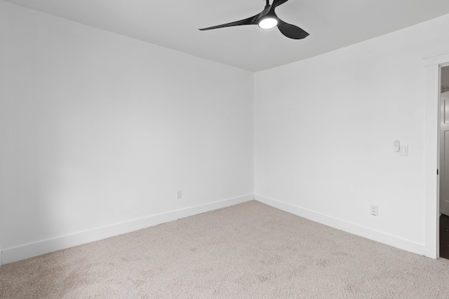 empty room featuring a ceiling fan, carpet flooring, and baseboards