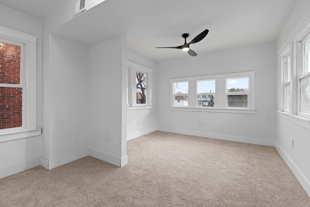 unfurnished room featuring carpet, visible vents, ceiling fan, and baseboards